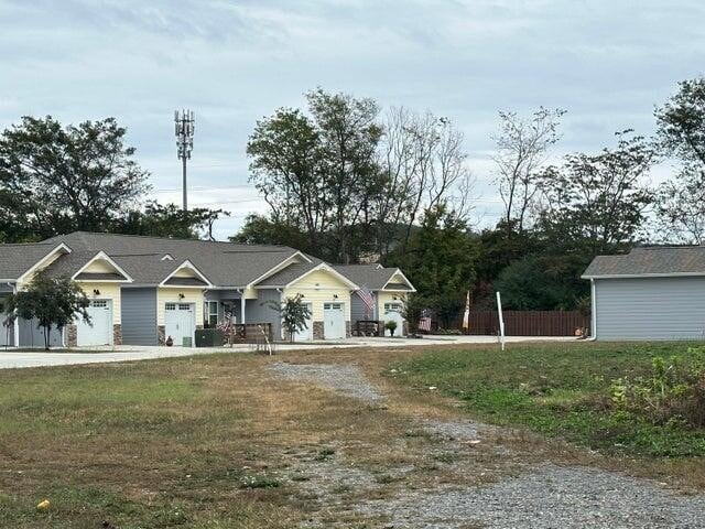 view of front of home with a garage and a front lawn