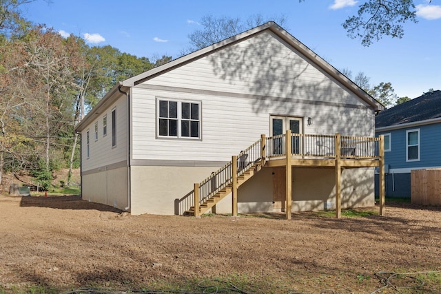 rear view of property featuring a deck