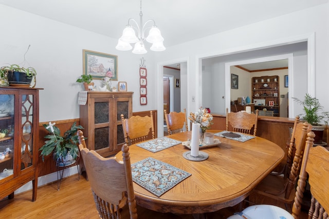 dining room featuring light wood-type flooring and a chandelier