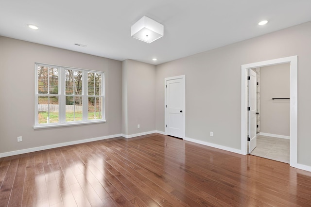 unfurnished room with wood-type flooring