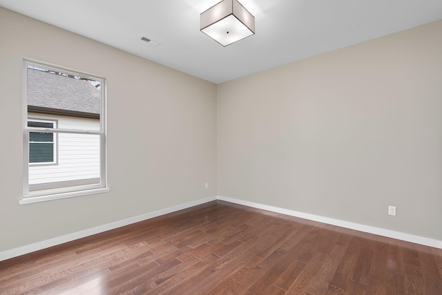 spare room with hardwood / wood-style floors