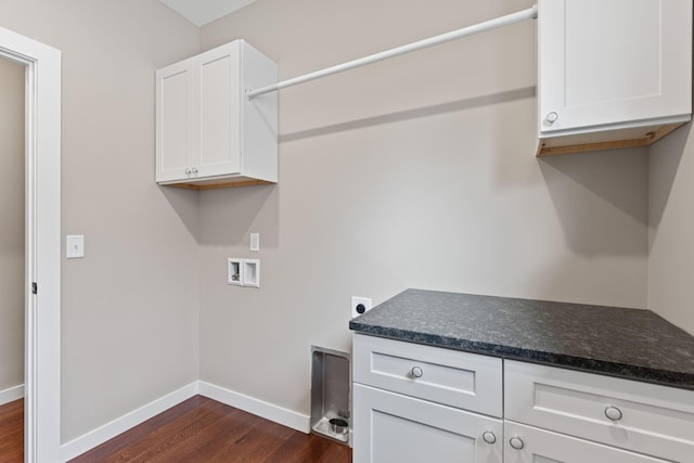 washroom featuring hookup for an electric dryer, cabinets, dark wood-type flooring, and hookup for a washing machine