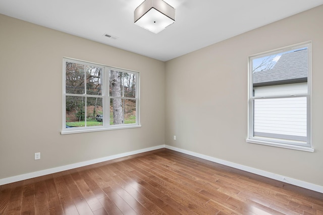 unfurnished room with hardwood / wood-style floors