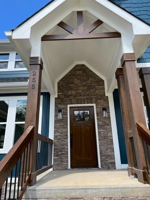 view of exterior entry with a porch