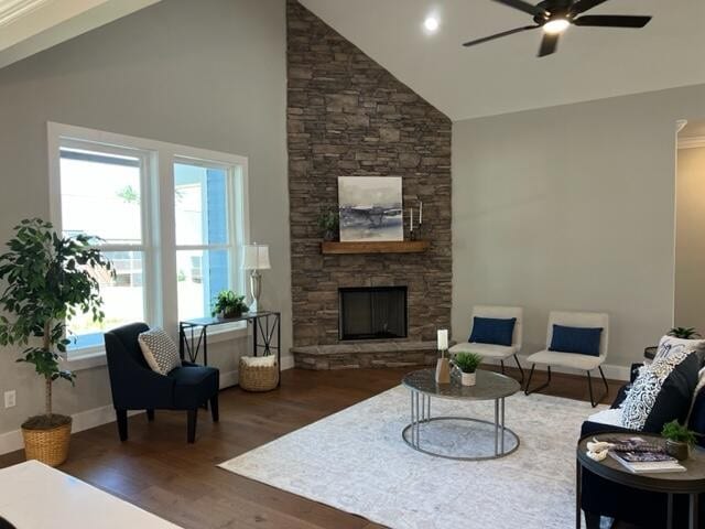 living room featuring high vaulted ceiling, ceiling fan, a fireplace, and dark hardwood / wood-style flooring