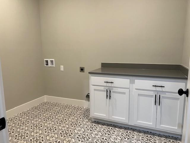 laundry room featuring hookup for a washing machine, cabinets, and electric dryer hookup