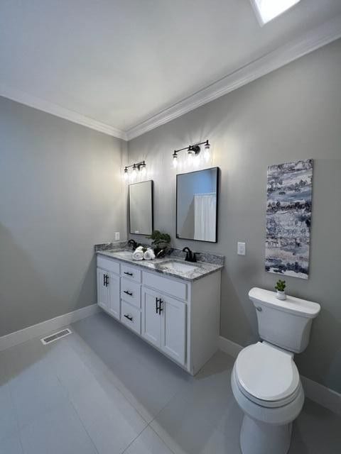 bathroom featuring crown molding, tile patterned flooring, vanity, and toilet