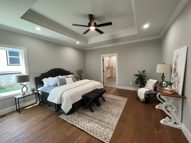 bedroom with ceiling fan, ensuite bathroom, and dark hardwood / wood-style flooring