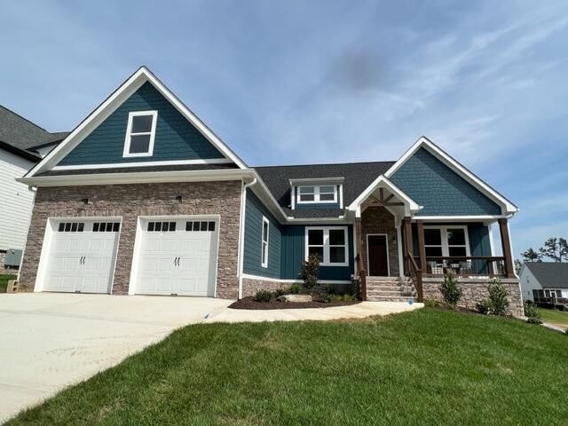 craftsman house with a garage and a front yard