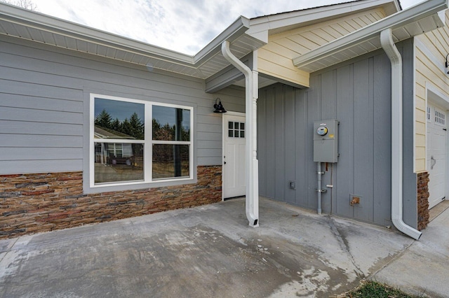 property entrance with a garage and a patio