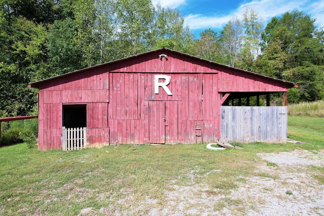 view of outbuilding featuring a yard