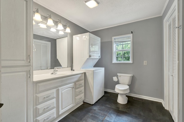 bathroom featuring stacked washer and clothes dryer, a textured ceiling, vanity, and toilet