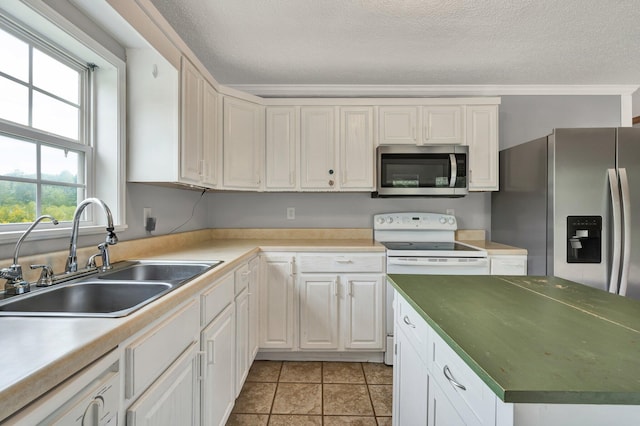 kitchen with sink, a textured ceiling, white cabinetry, stainless steel appliances, and crown molding