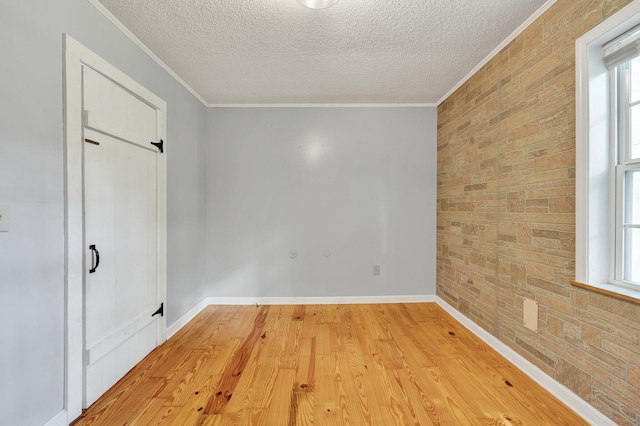 unfurnished room featuring light hardwood / wood-style floors and ornamental molding