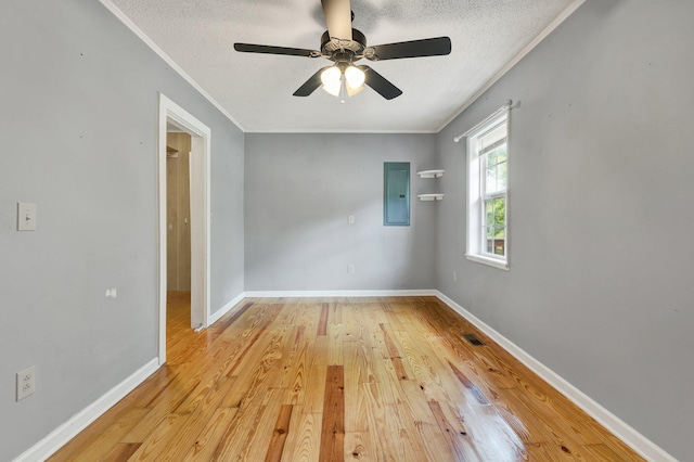 empty room with ceiling fan, a textured ceiling, crown molding, and light hardwood / wood-style floors