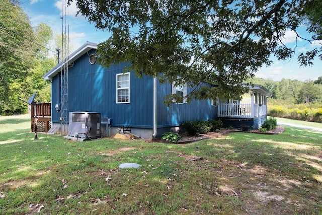 view of home's exterior with a deck and a lawn