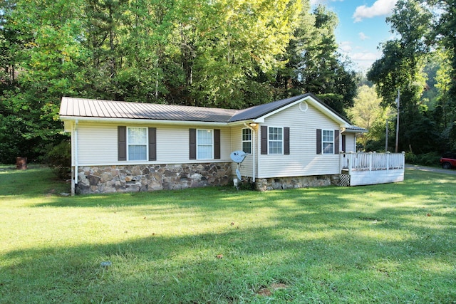 ranch-style house with a deck and a front lawn