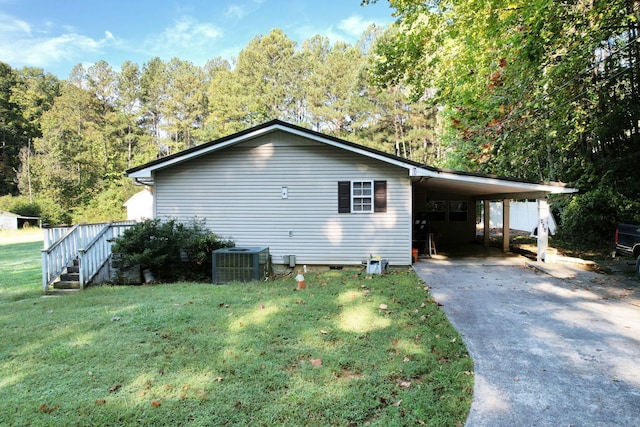 view of side of home featuring a lawn, a carport, and central air condition unit