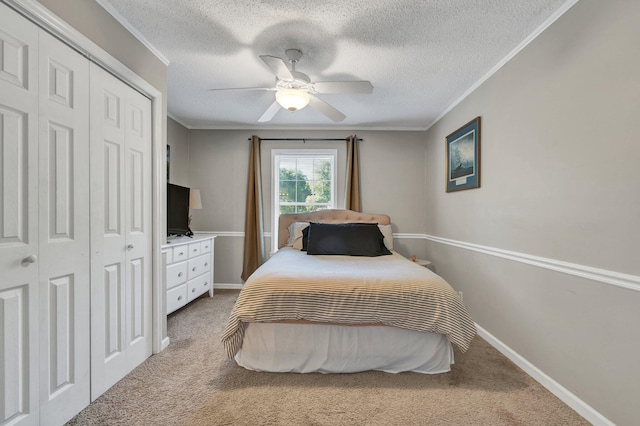 bedroom featuring ornamental molding, carpet, ceiling fan, and a textured ceiling