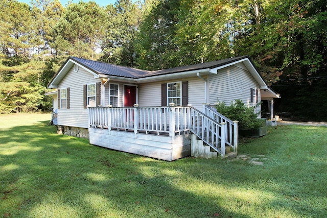 view of front of house featuring a front lawn and a deck