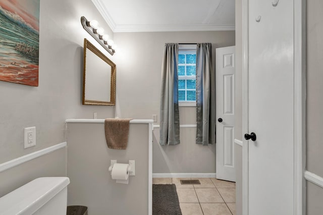 bathroom featuring crown molding, toilet, and tile patterned flooring