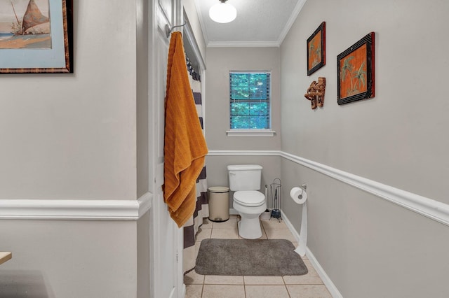 bathroom with crown molding, toilet, and tile patterned floors