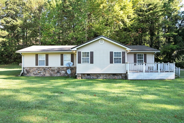 ranch-style home with a front yard and a deck