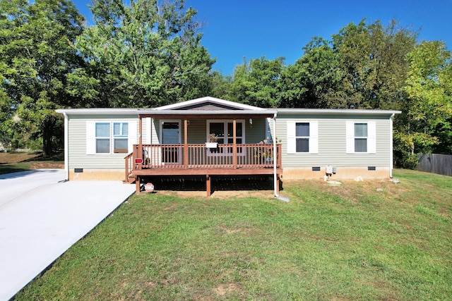 manufactured / mobile home featuring a deck and a front yard