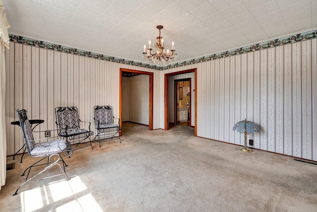 sitting room featuring an inviting chandelier and carpet floors