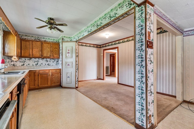 kitchen with black dishwasher, sink, light carpet, ceiling fan, and stainless steel dishwasher