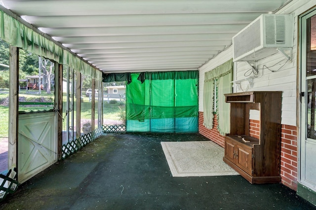 unfurnished sunroom featuring a wall mounted air conditioner