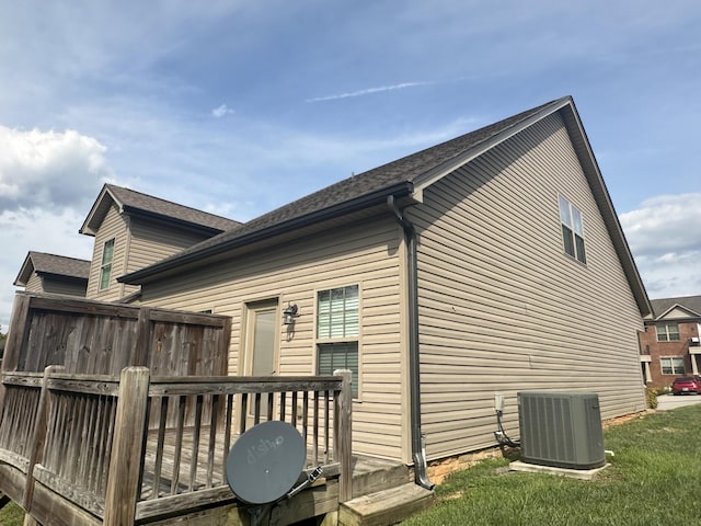 exterior space with central AC unit and a wooden deck