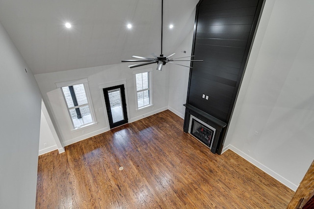 unfurnished living room with dark hardwood / wood-style floors, ceiling fan, and lofted ceiling