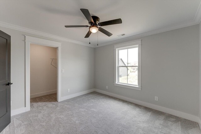 111 Arthur Ln NW, Cleveland, TN 37312 - unfurnished bedroom with a walk in closet, crown molding, light colored carpet, baseboards, and ceiling fan