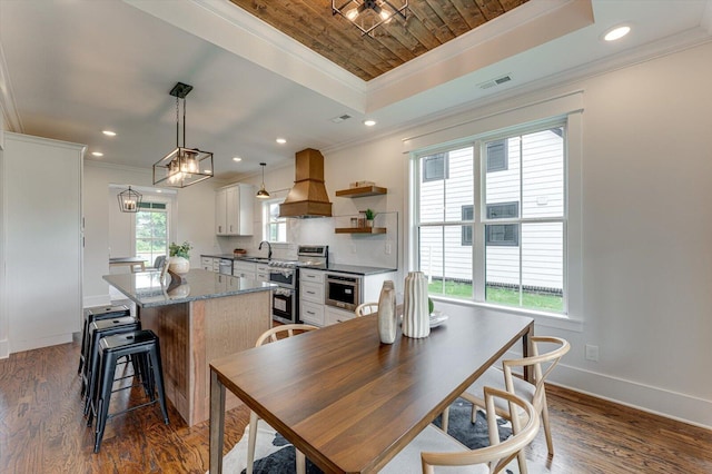 111 Arthur Ln NW, Cleveland, TN 37312 - kitchen with custom range hood, crown molding, a kitchen island, range with two ovens, and a raised ceiling