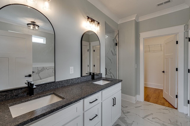 bathroom with vanity, hardwood / wood-style flooring, and crown molding