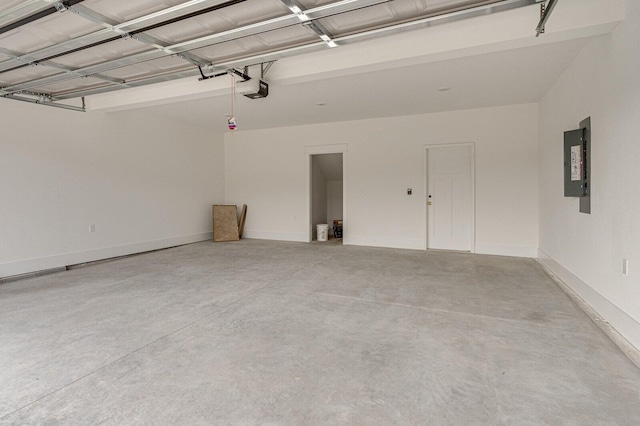 garage featuring electric panel and a garage door opener