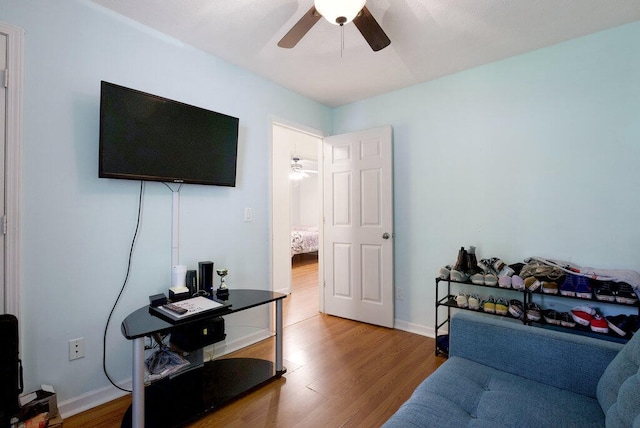 living room with hardwood / wood-style floors and ceiling fan