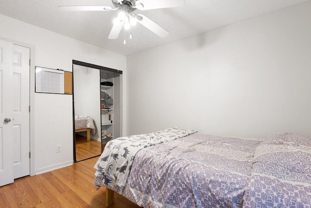 bedroom featuring ceiling fan, a closet, and wood-type flooring