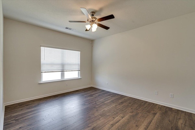 empty room with ceiling fan, a textured ceiling, and dark hardwood / wood-style floors