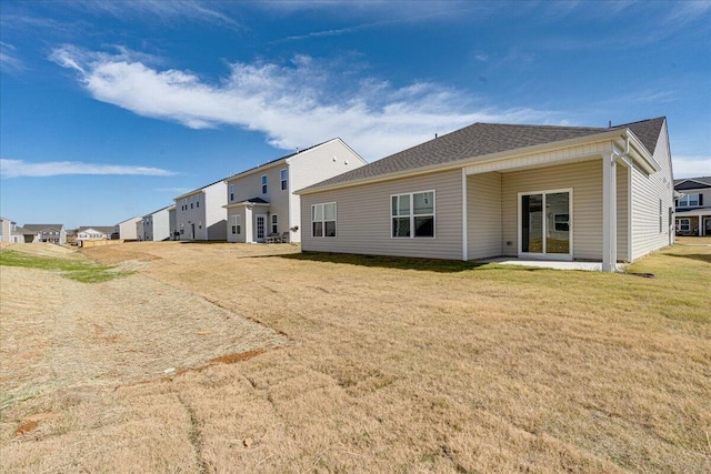 back of house featuring a patio area and a yard