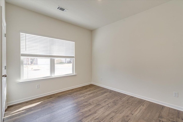 spare room with wood-type flooring