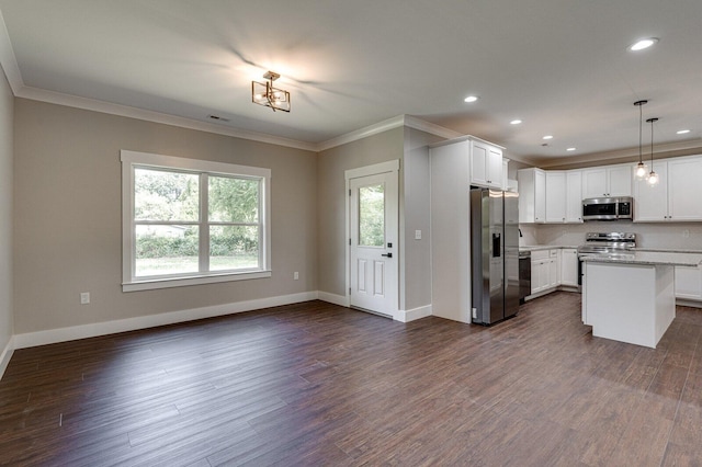 kitchen featuring hanging light fixtures, white cabinets, dark hardwood / wood-style flooring, stainless steel appliances, and a center island