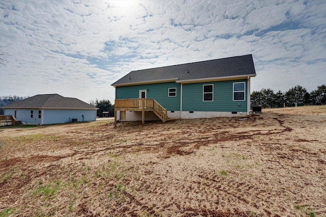 back of house featuring a deck