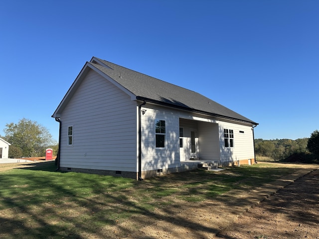 back of property featuring a yard