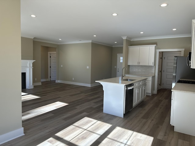 kitchen featuring a kitchen island with sink, sink, white cabinetry, appliances with stainless steel finishes, and dark hardwood / wood-style flooring