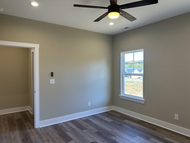 empty room with dark wood-type flooring and ceiling fan