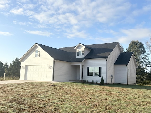 view of front of house featuring a front yard and a garage