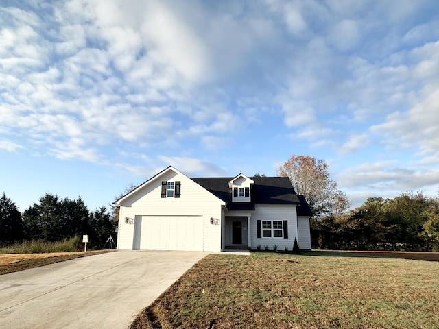 view of front of property with a front lawn and a garage