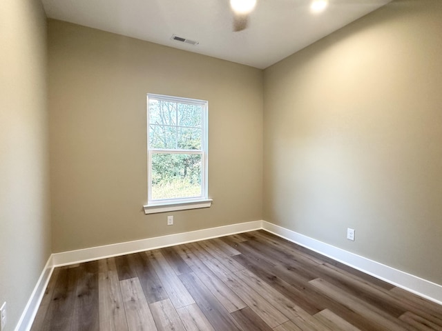 unfurnished room with ceiling fan and dark hardwood / wood-style flooring